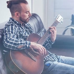 man playing guitar in music therapy