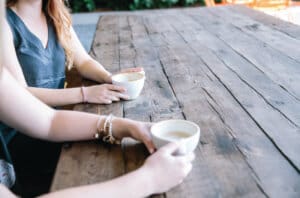 two women discuss the opioid epidemic over coffee 